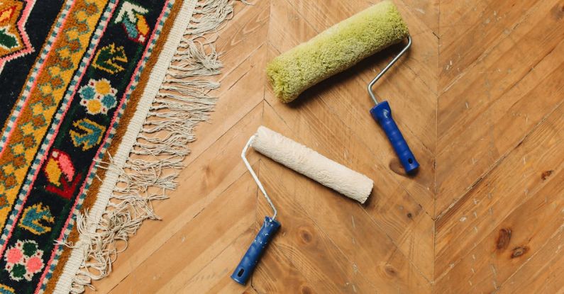 Tools - Paint Rollers Lying on a Wooden Floor